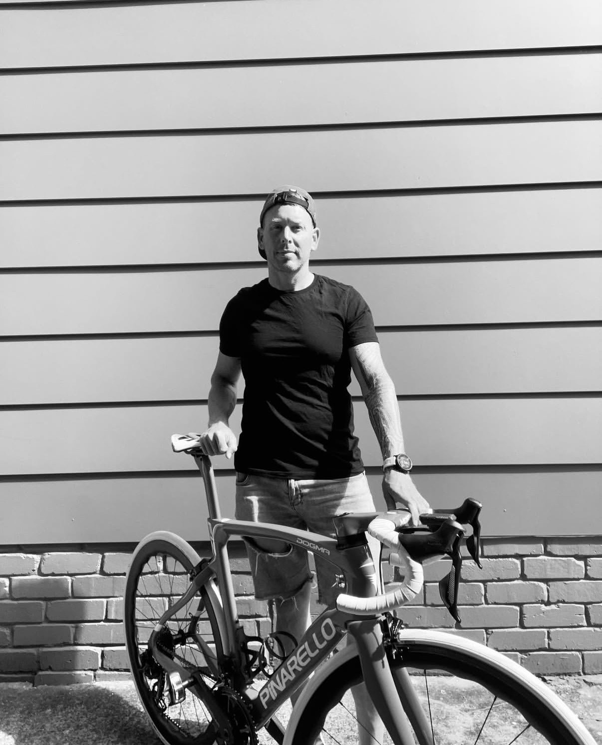Phillipe Cossey standing beside his Pinarello Dogma, black and white