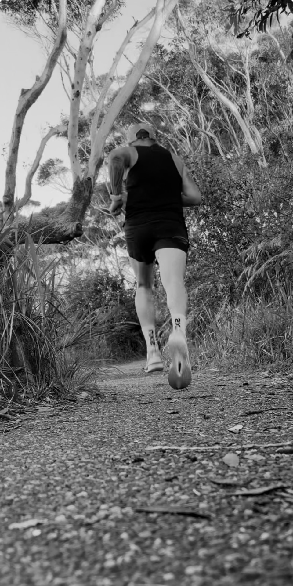 Runner on a bush trail at first light, no watch in sight