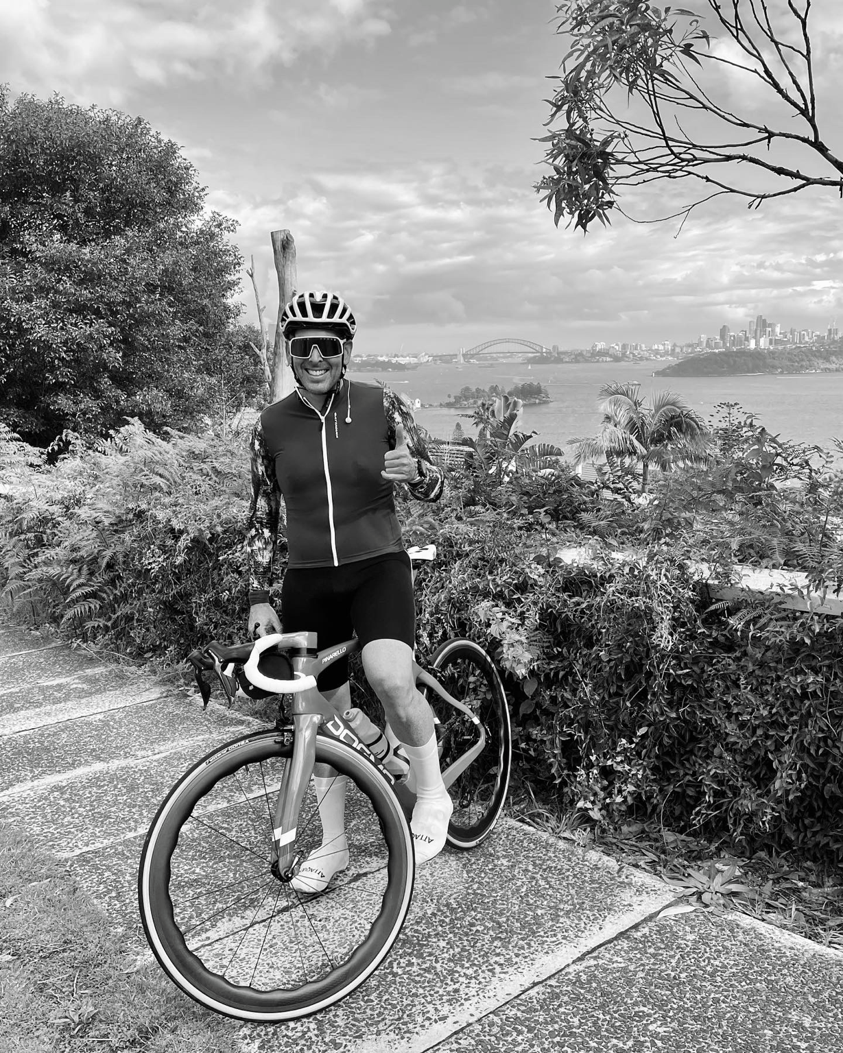 Phillipe with his bike, Sydney harbour in the background